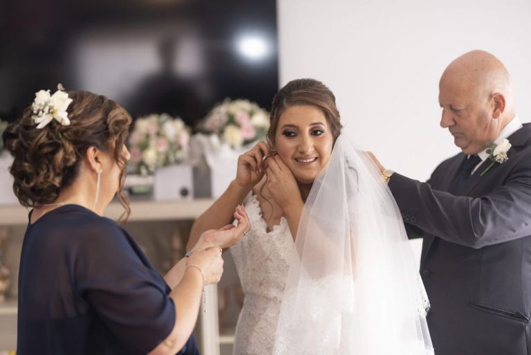 parents helping bride get ready